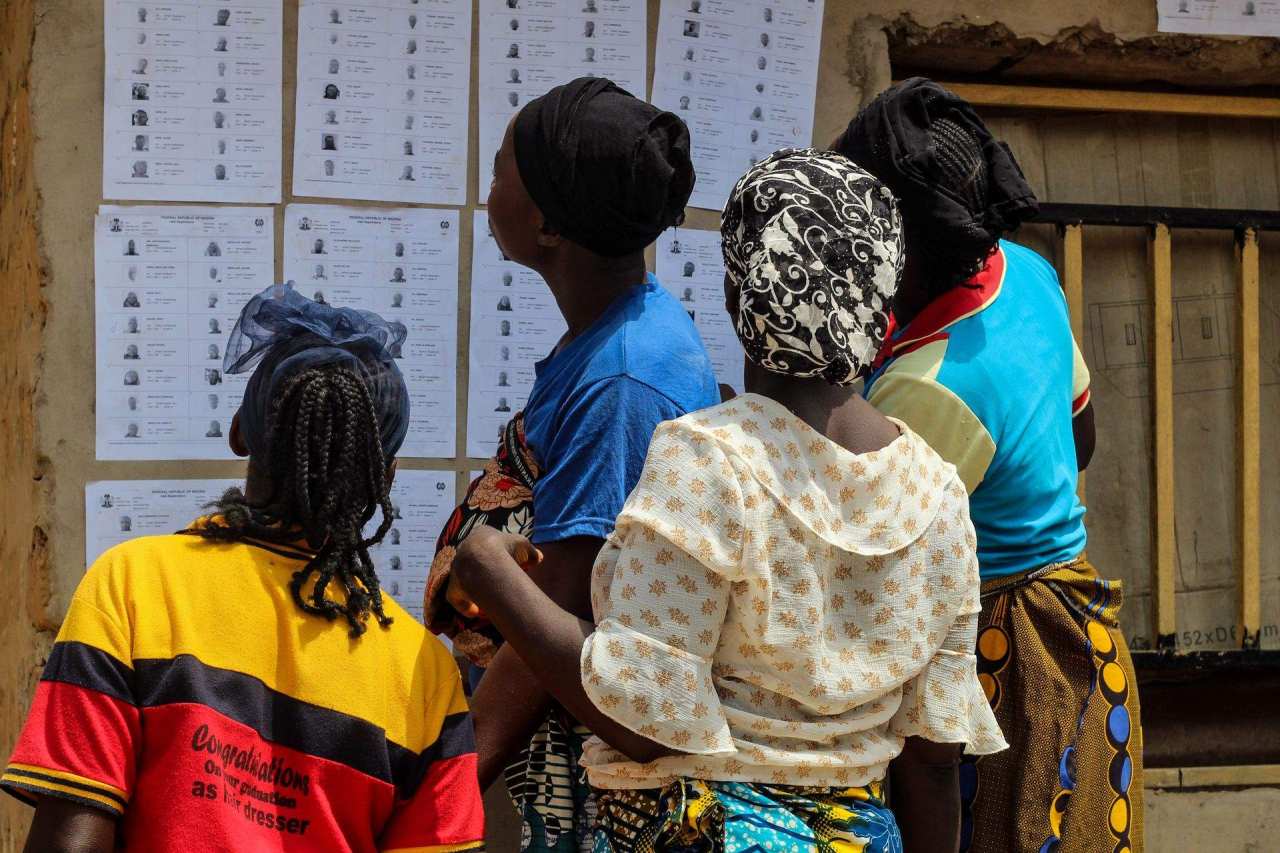 Community members reviewing information displayed on a wall