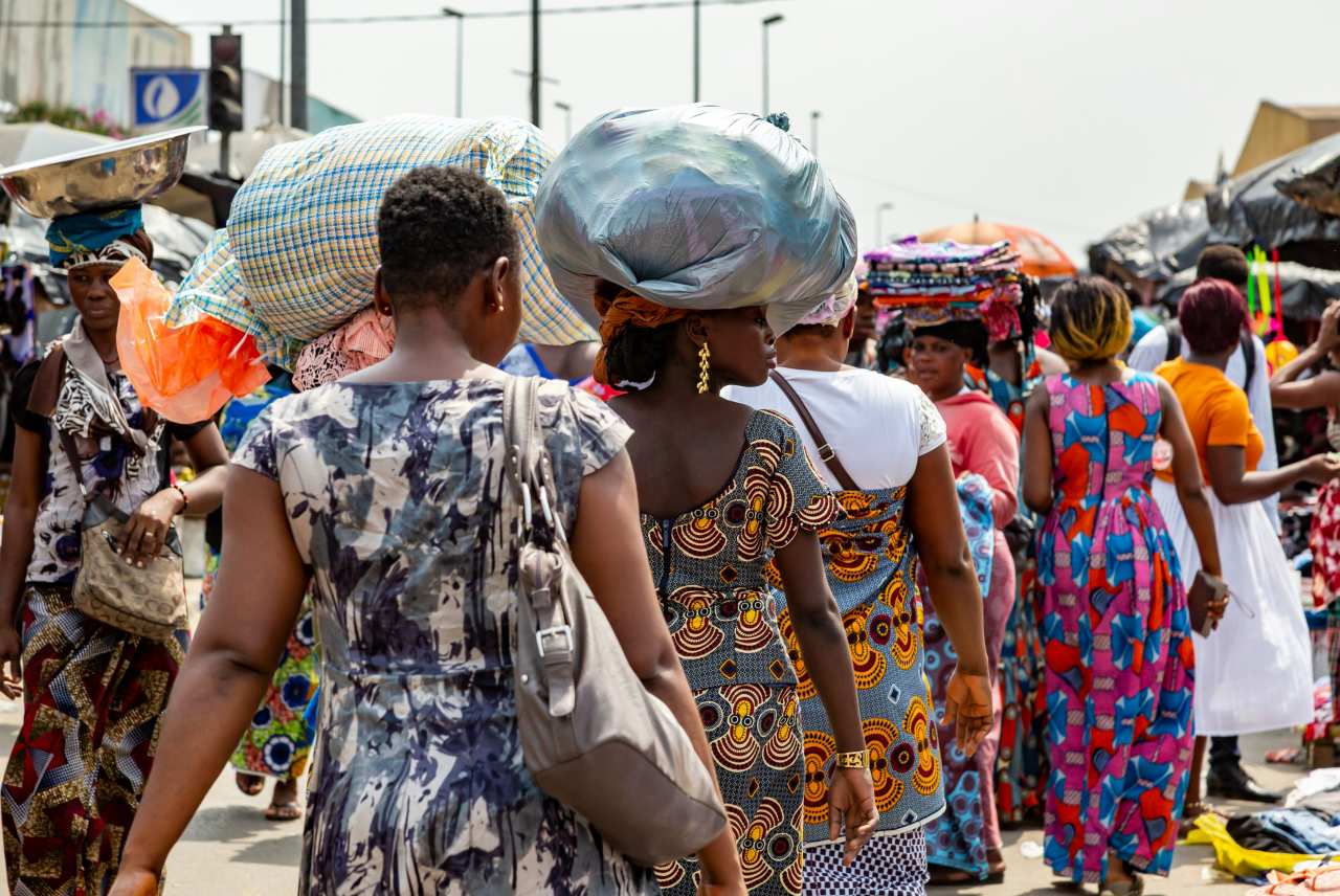 Women moving through a busy open-air market